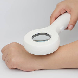Professional using Wood's Lamp for skin inspection