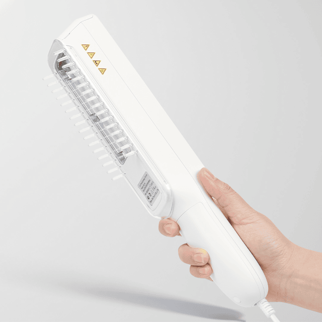 Hand holding BU-10 narrowband UVB lamp with irradiation window and light comb